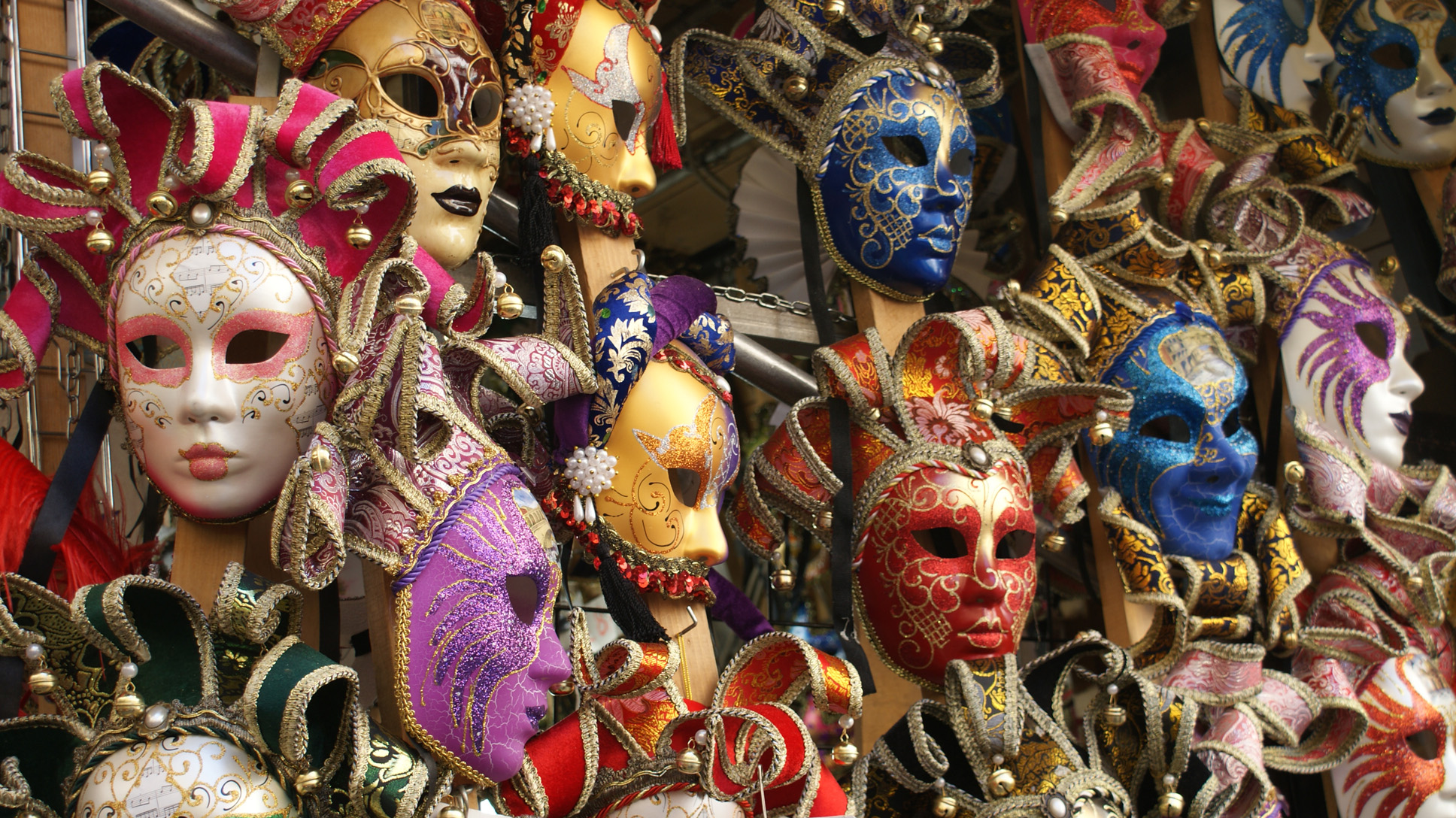 many different colors of masquerade masks on display