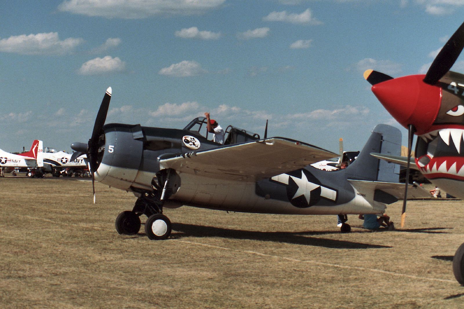 a group of planes sit on display at an airshow