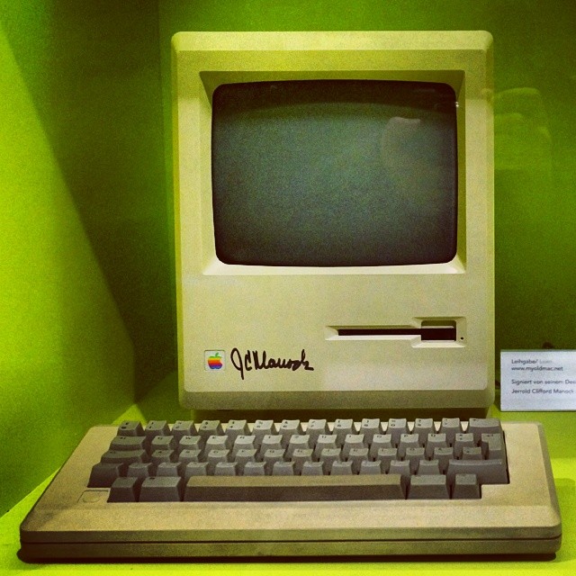 an old apple computer on display in a museum