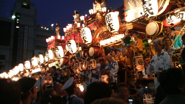 people with cameras and a large display of chinese lanterns