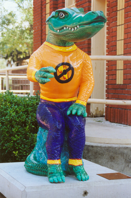 a plastic alligator statue in front of a building