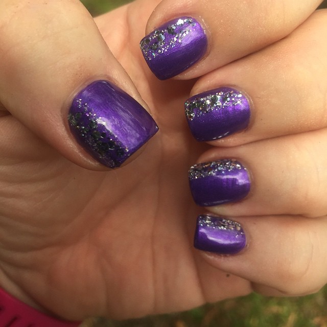 a person is holding purple and silver nails