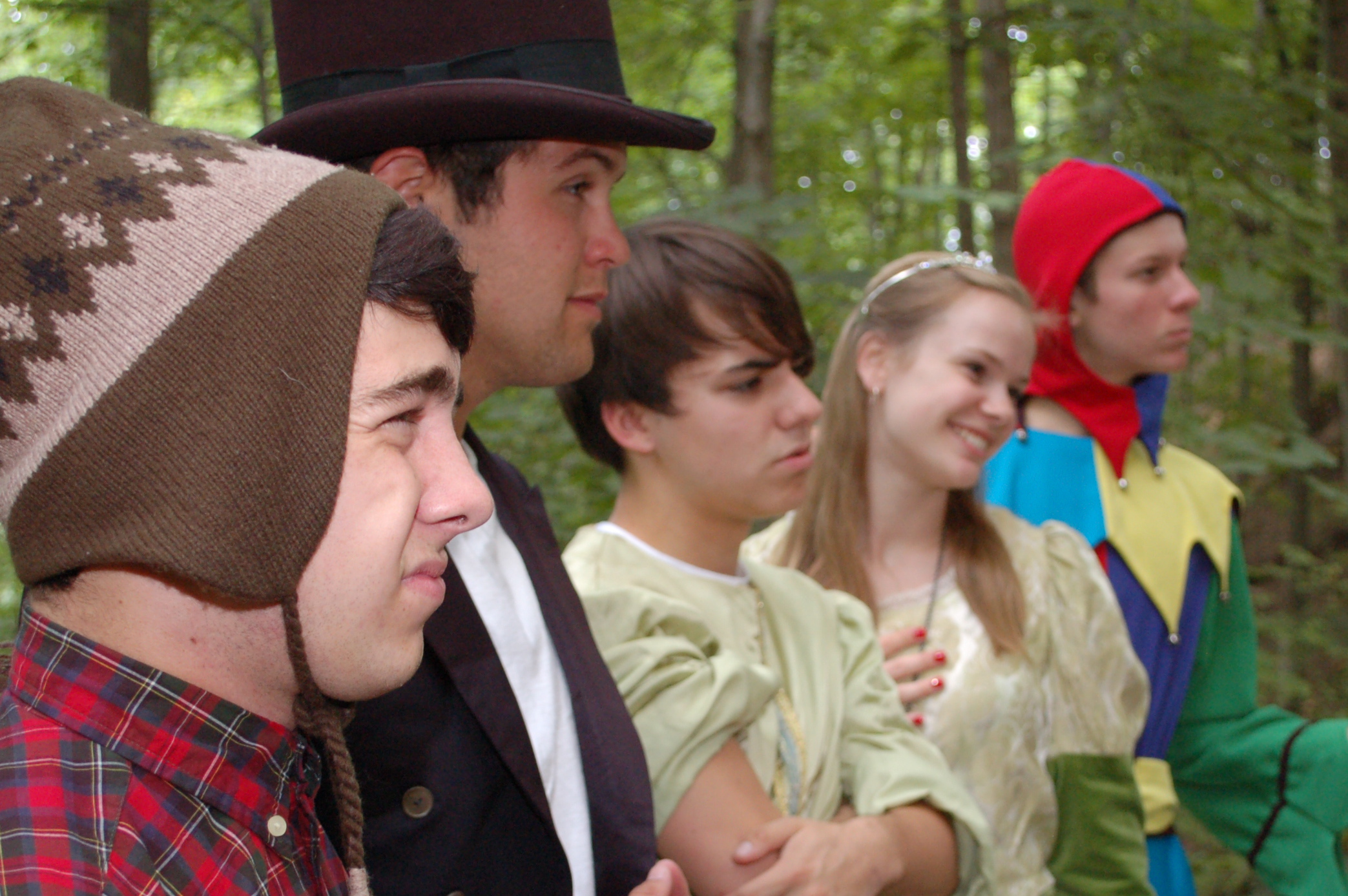 group of people with coats on in the woods