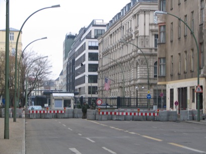 an empty city street lined with buildings and traffic cones
