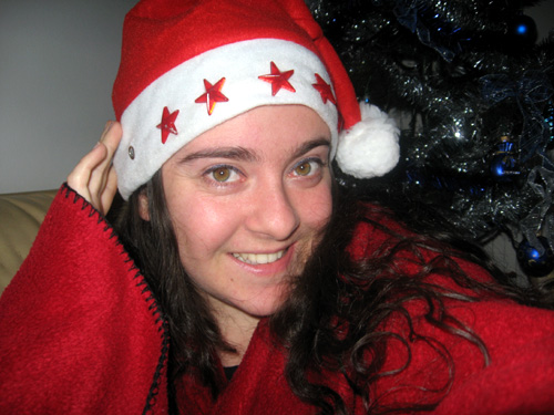 a woman wearing red and white clothes with a santa claus hat