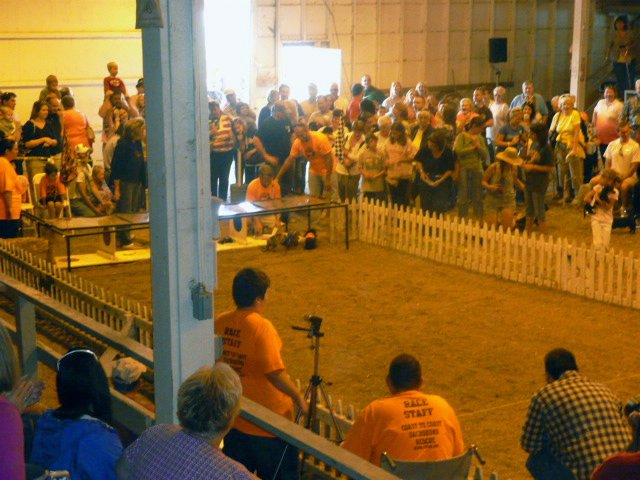 a crowded arena with people watching as the performers perform