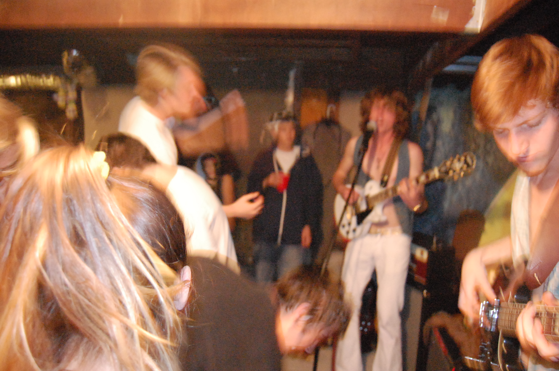 a group of young people standing around a bar