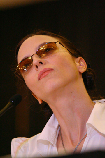 a woman in glasses looking off into the distance