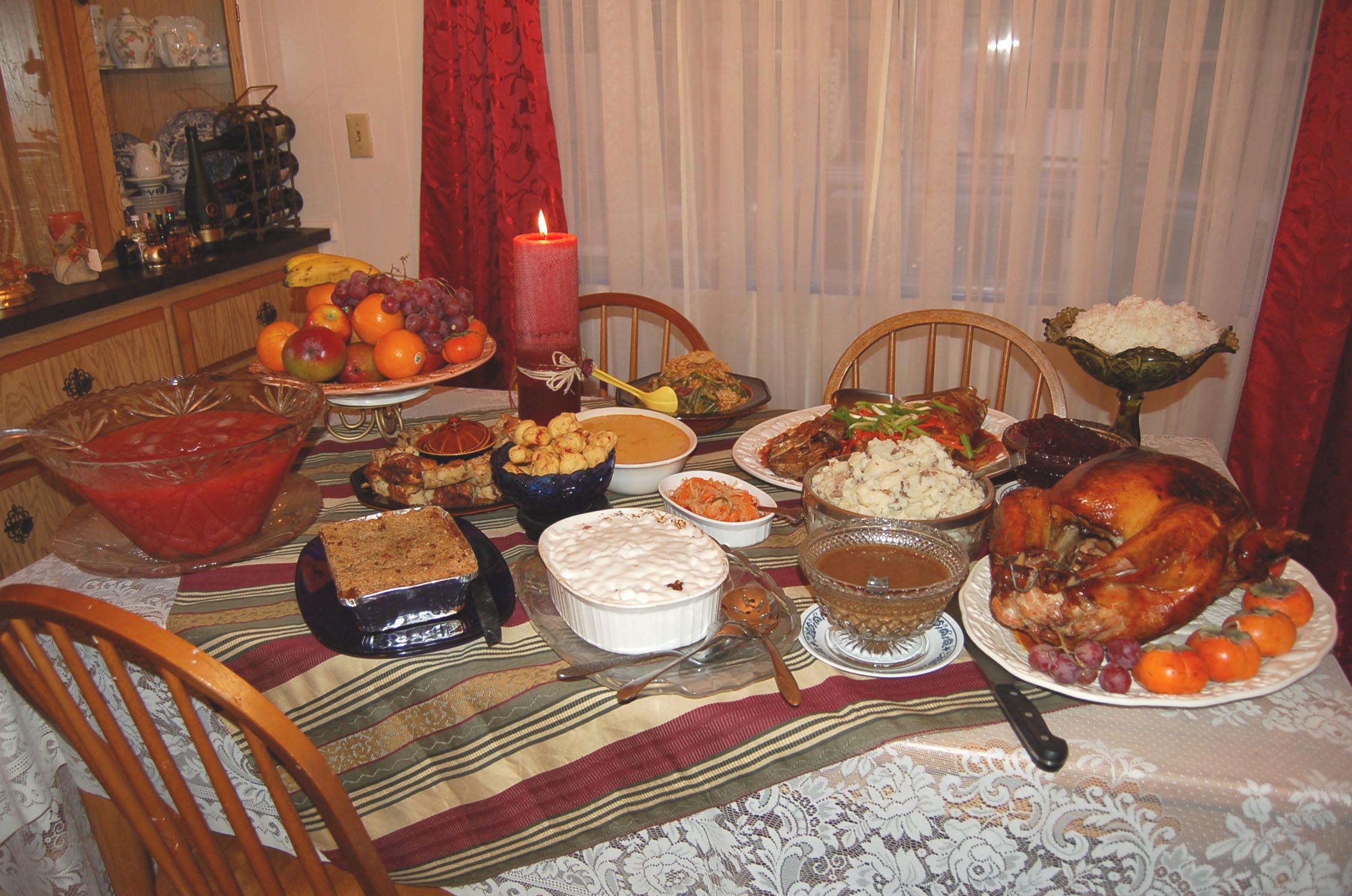 dinner is served on table with turkey and other food