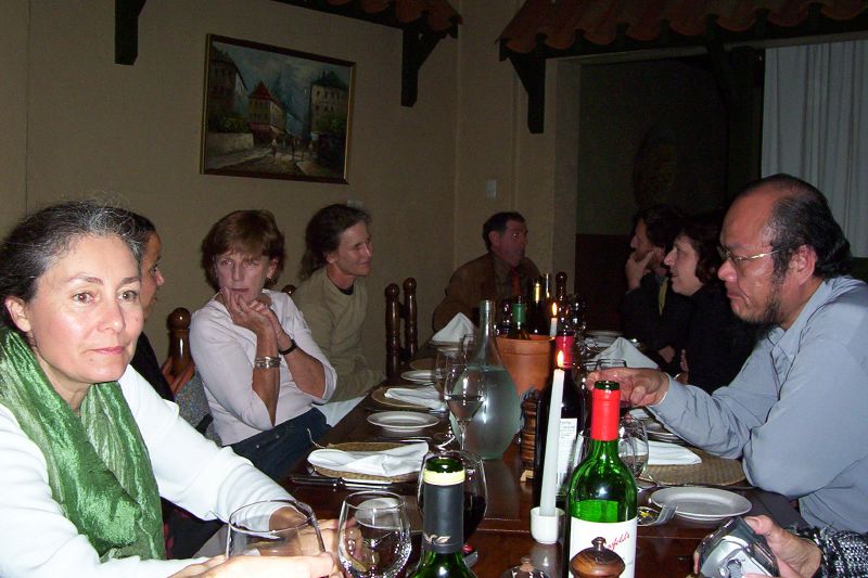 a group of people at a table eating dinner