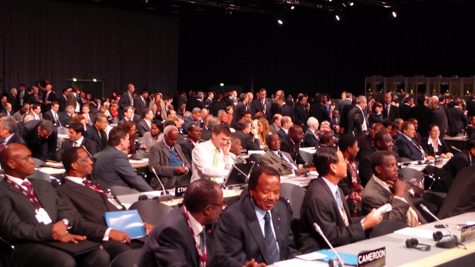 people sitting at tables in the middle of a conference