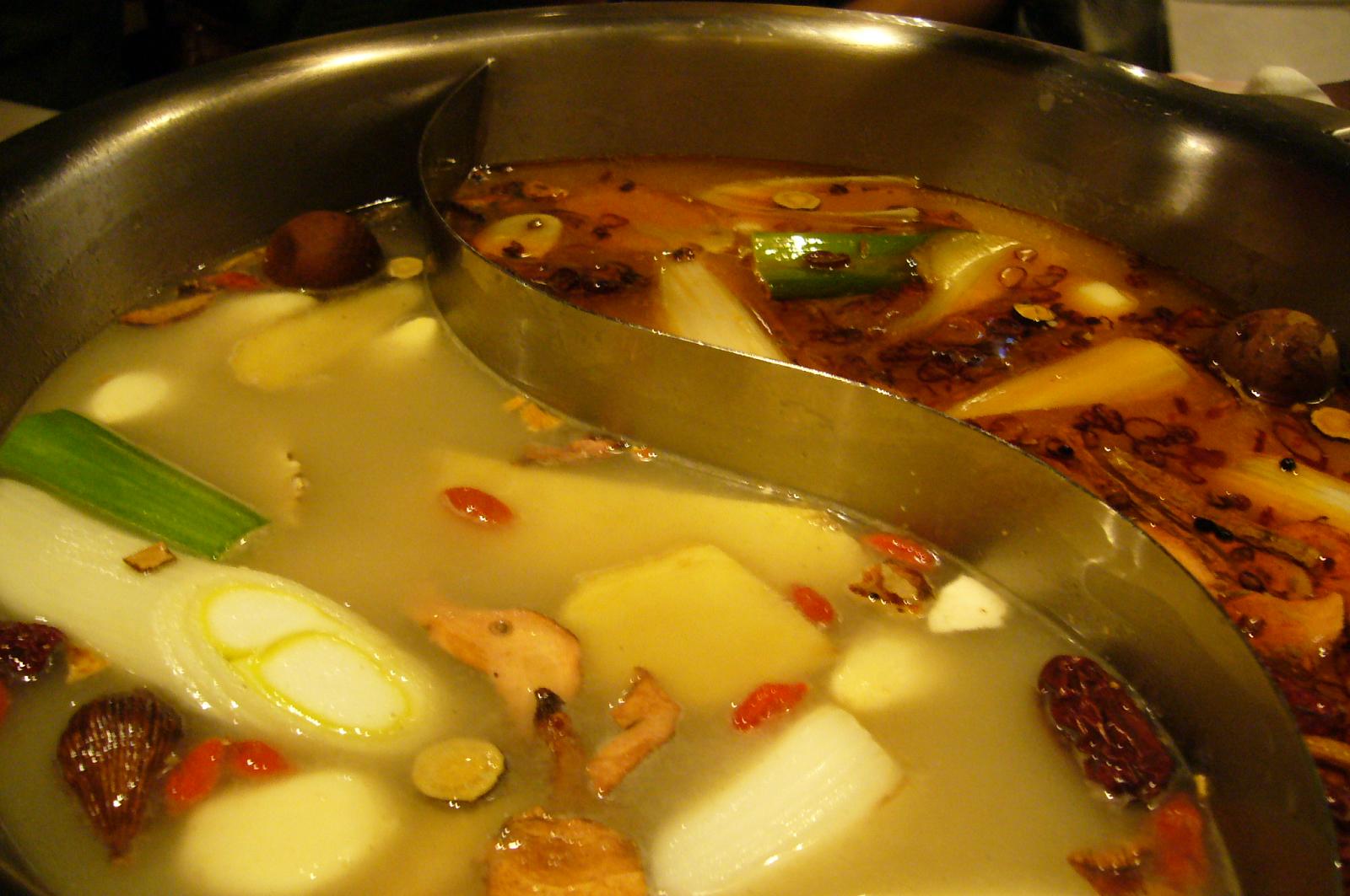 some soup with broth, meats and vegetables being cooked