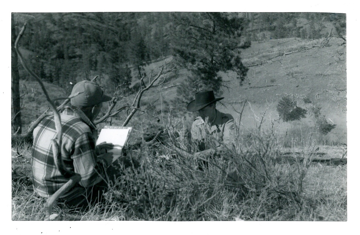 an old po of a man looking at a deer