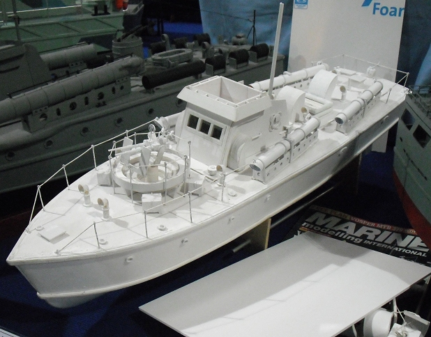 a model of a boat and a larger one on a stand