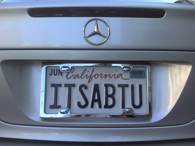 a plate with the word it saut is displayed in front of a car