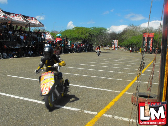a motorcyclist on a racing track being followed by an audience