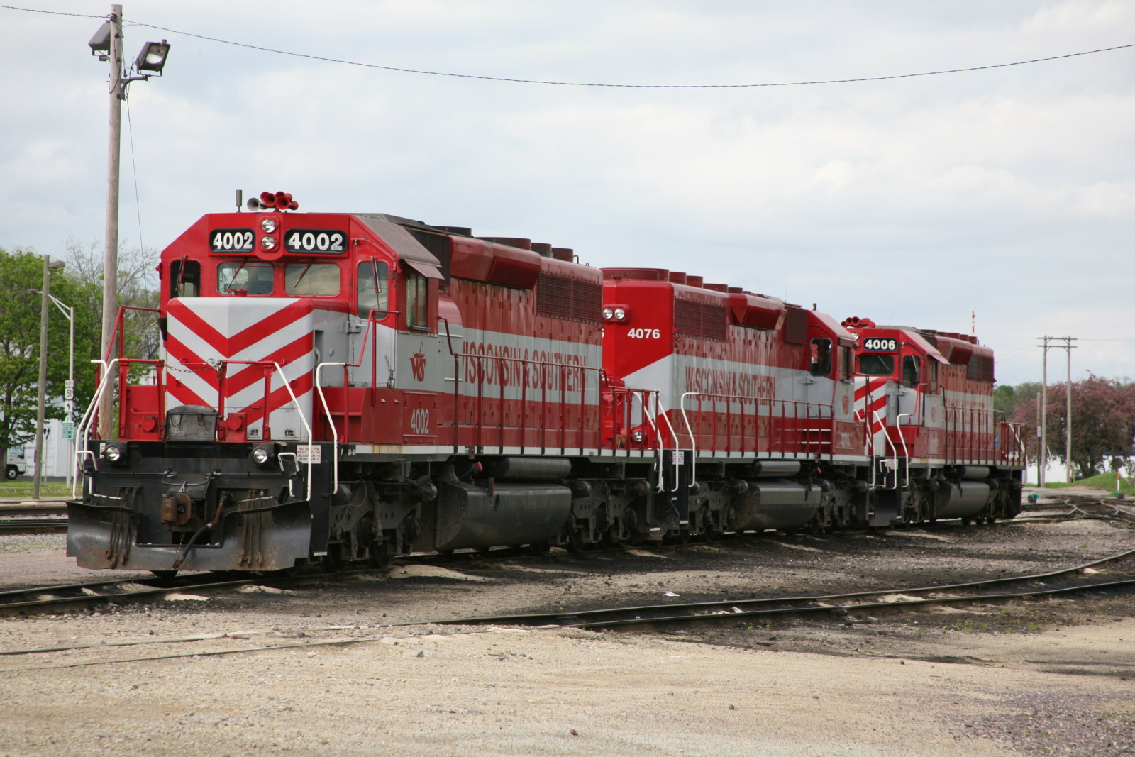 the red and white train is traveling on the tracks