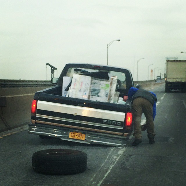 a man is loading a huge truck with items in the bed