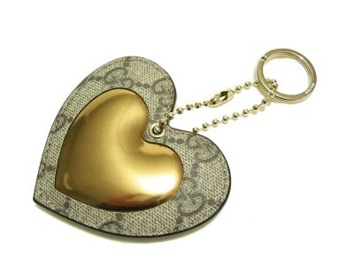 a brown and beige heart shaped keychain on white background