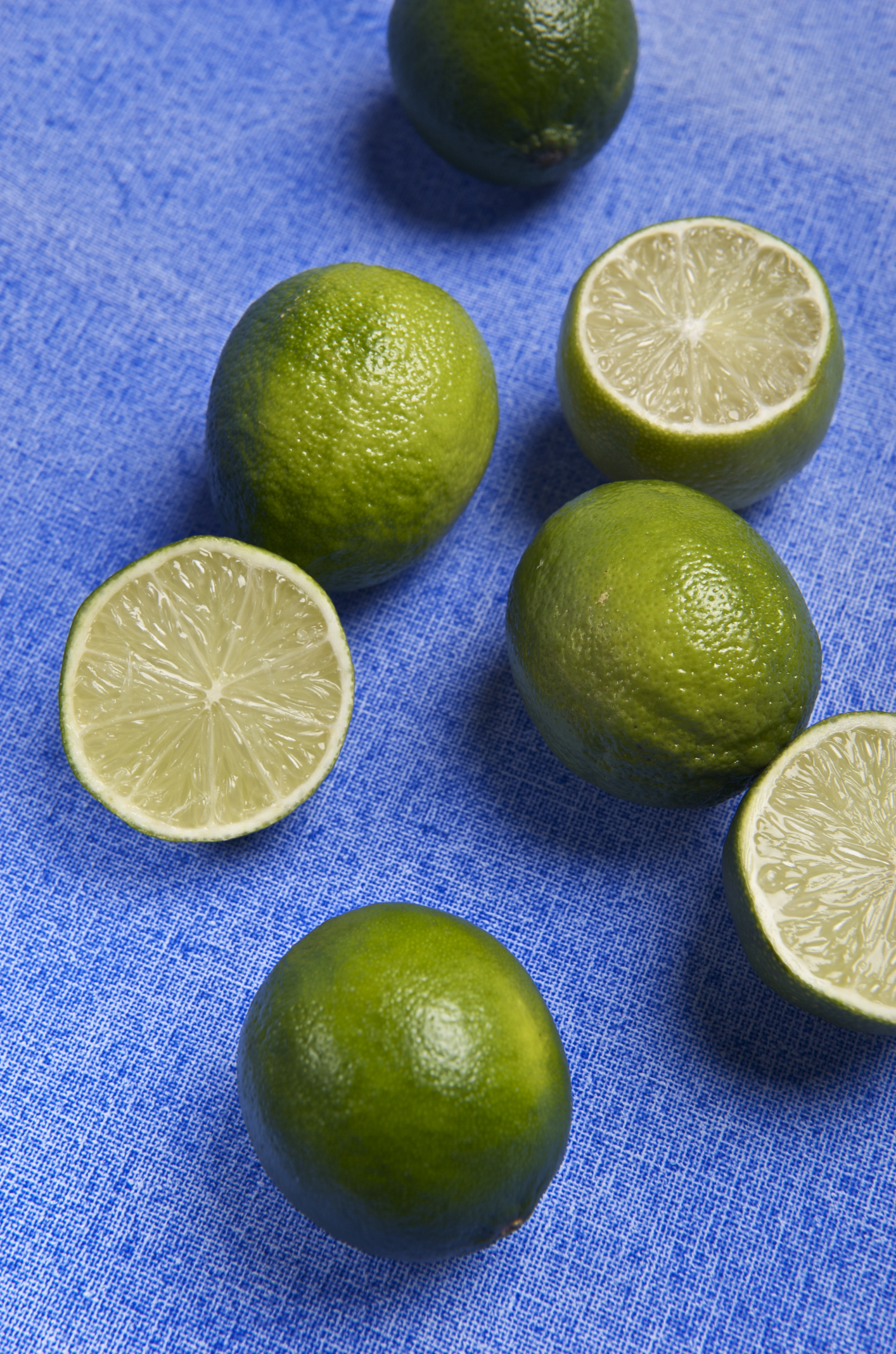 limes cut in half are displayed on a table