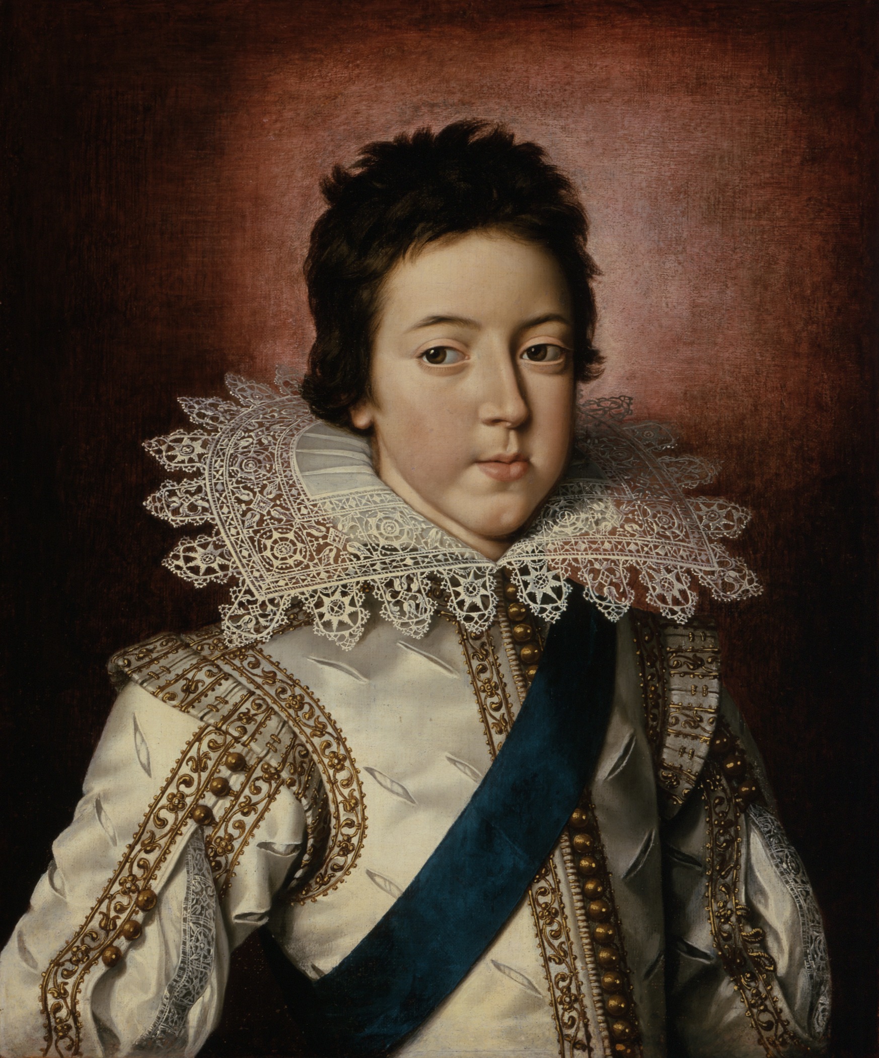 a young man in an old - fashioned white gown with a blue sash