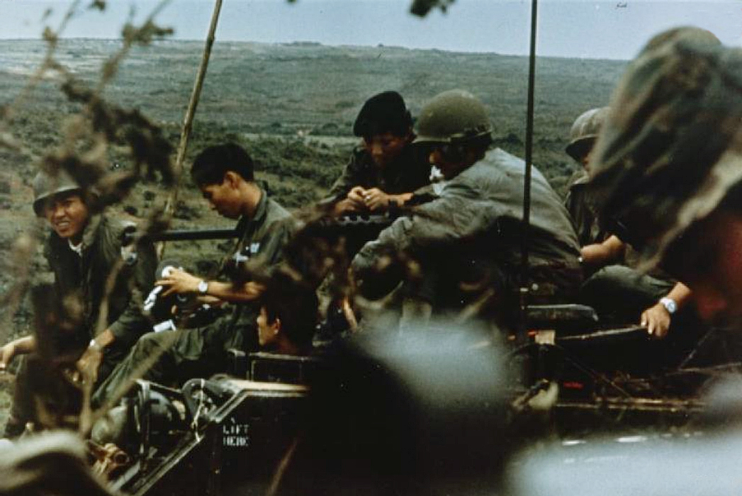 a group of men sitting next to each other on a hillside