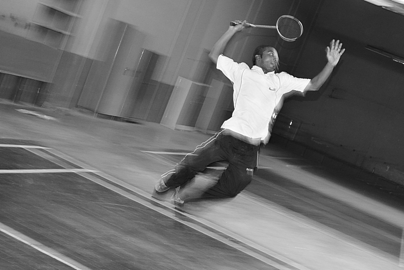 man playing tennis in black and white