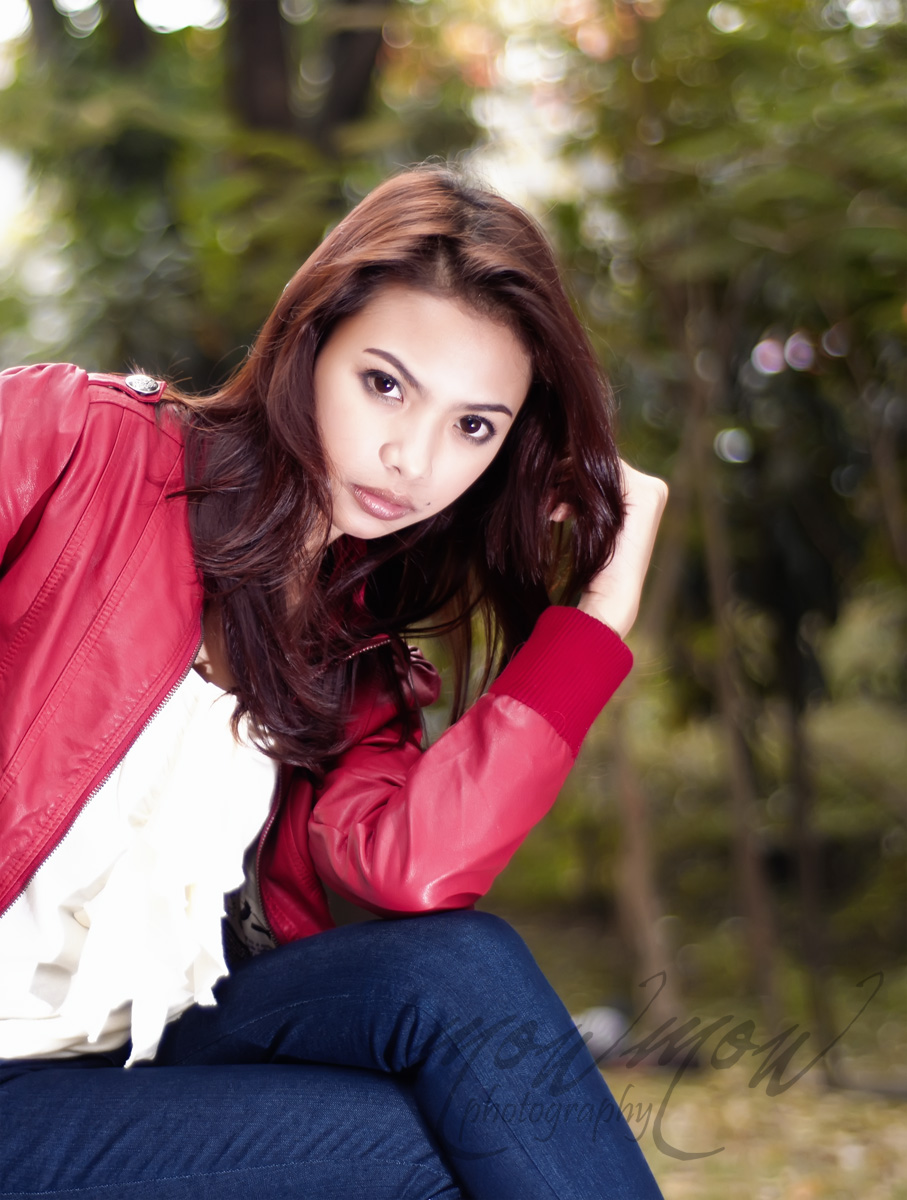 a woman with long hair wearing a leather jacket