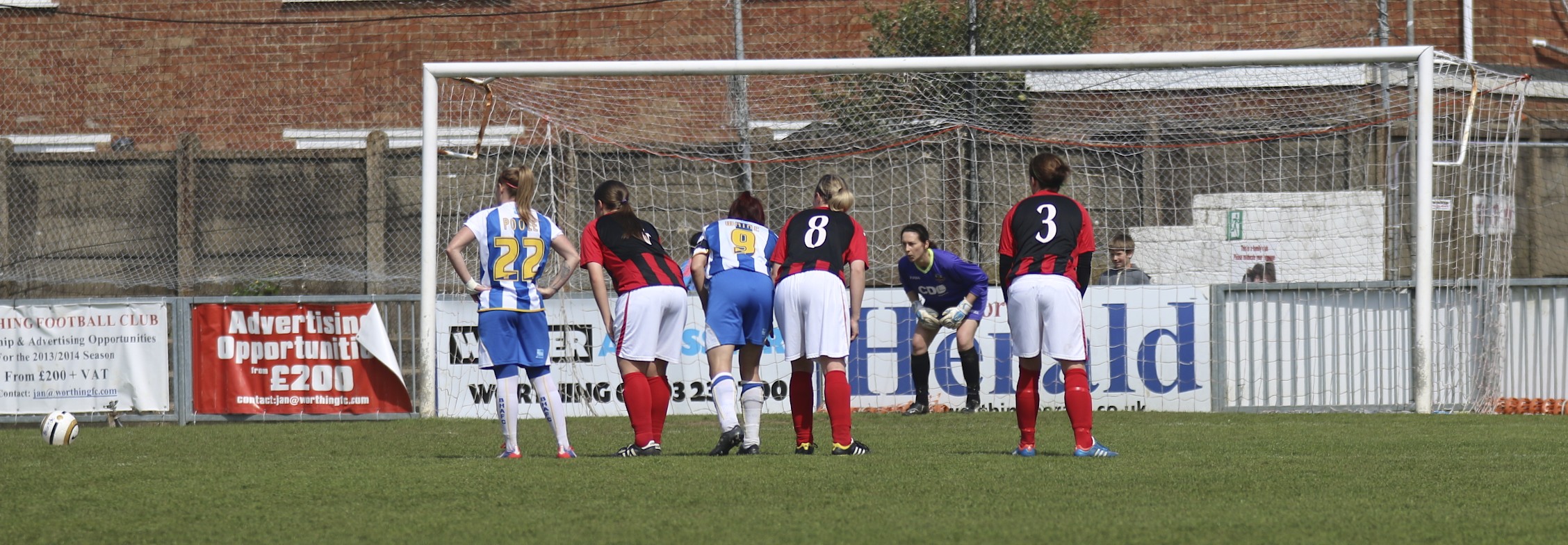 a group of people are standing on the field and talking