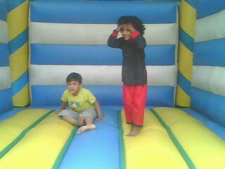 two children in an inflatable jumping castle