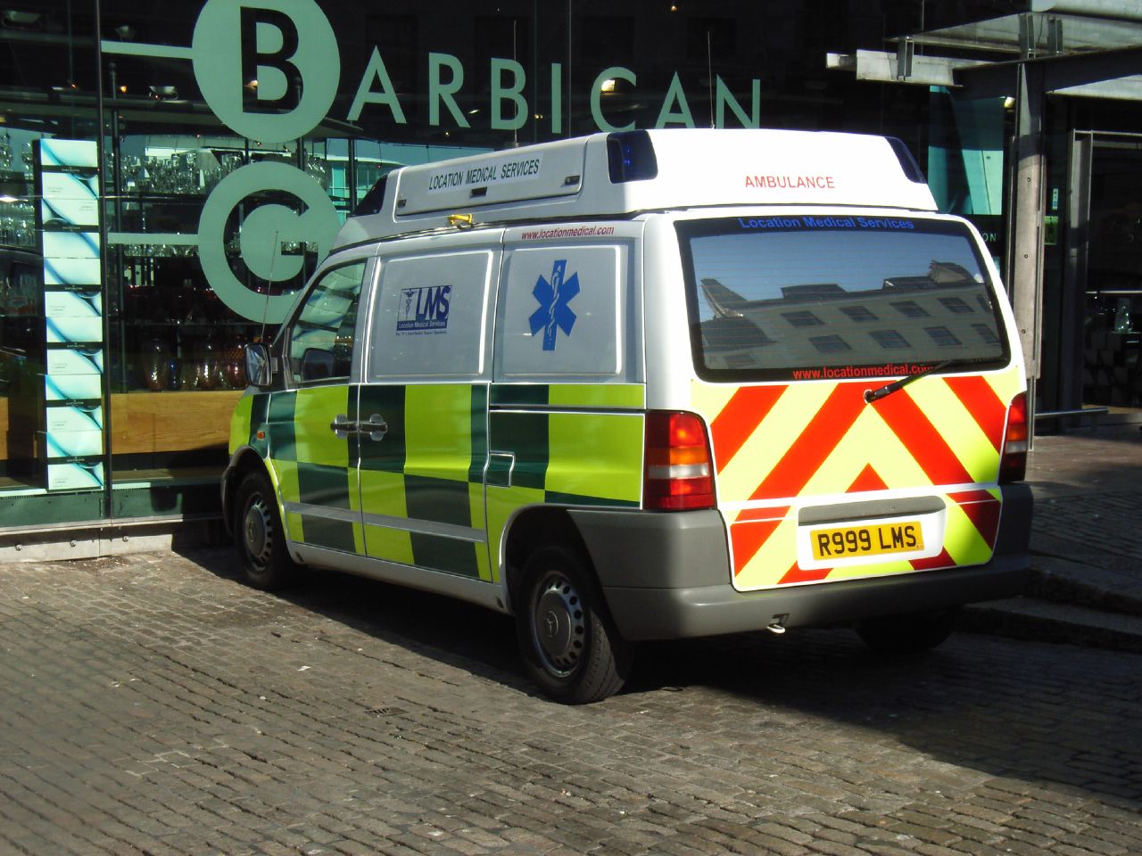 a van is parked on the street near a building