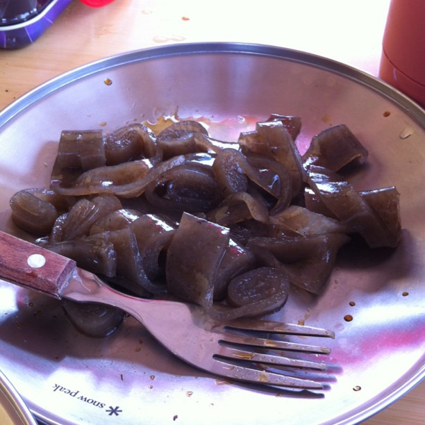 cooked eggplant on silver plate with metal fork and utensils