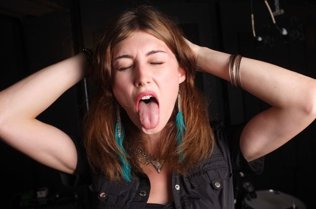 a woman sticks her tongue out in surprise
