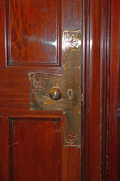 a door with the handle on a wooden door