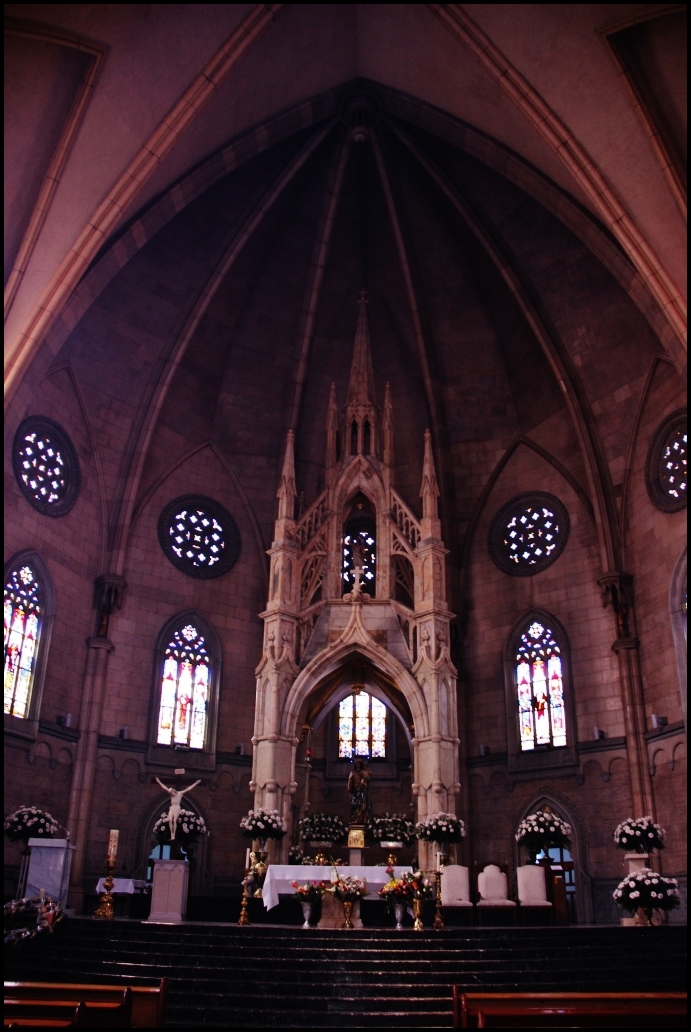 inside of a church that has pews and stained glass windows