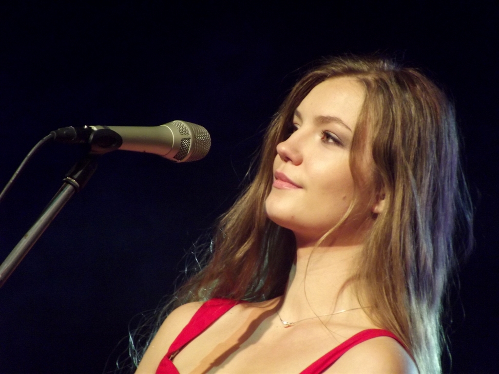 a woman that is standing by a microphone