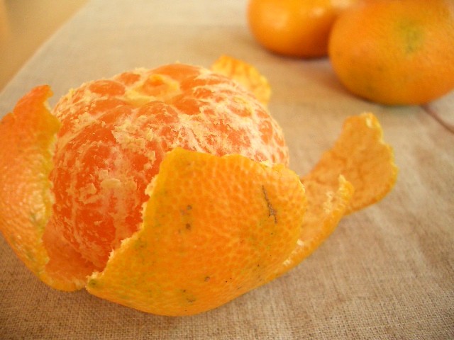 a peeled orange is sitting on a table