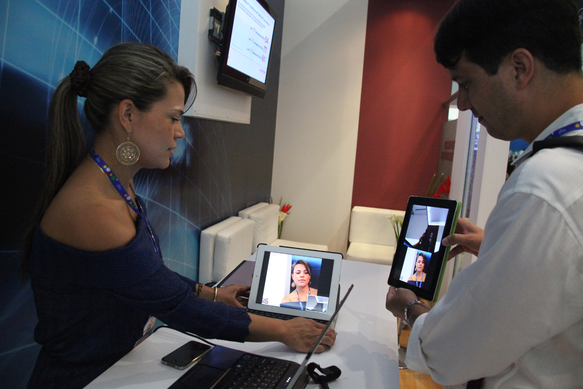 a man standing next to a woman with an electronic device