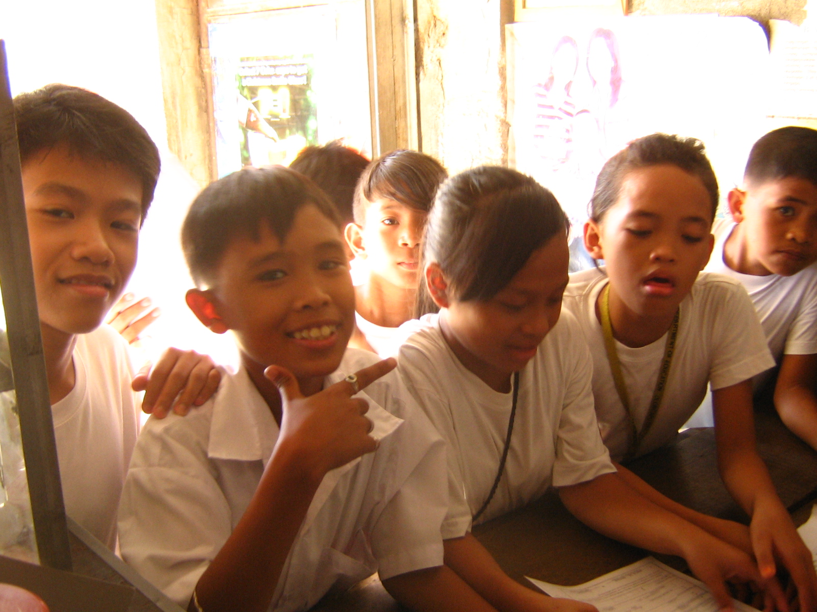 some school boys wearing white shirts and listening to someone