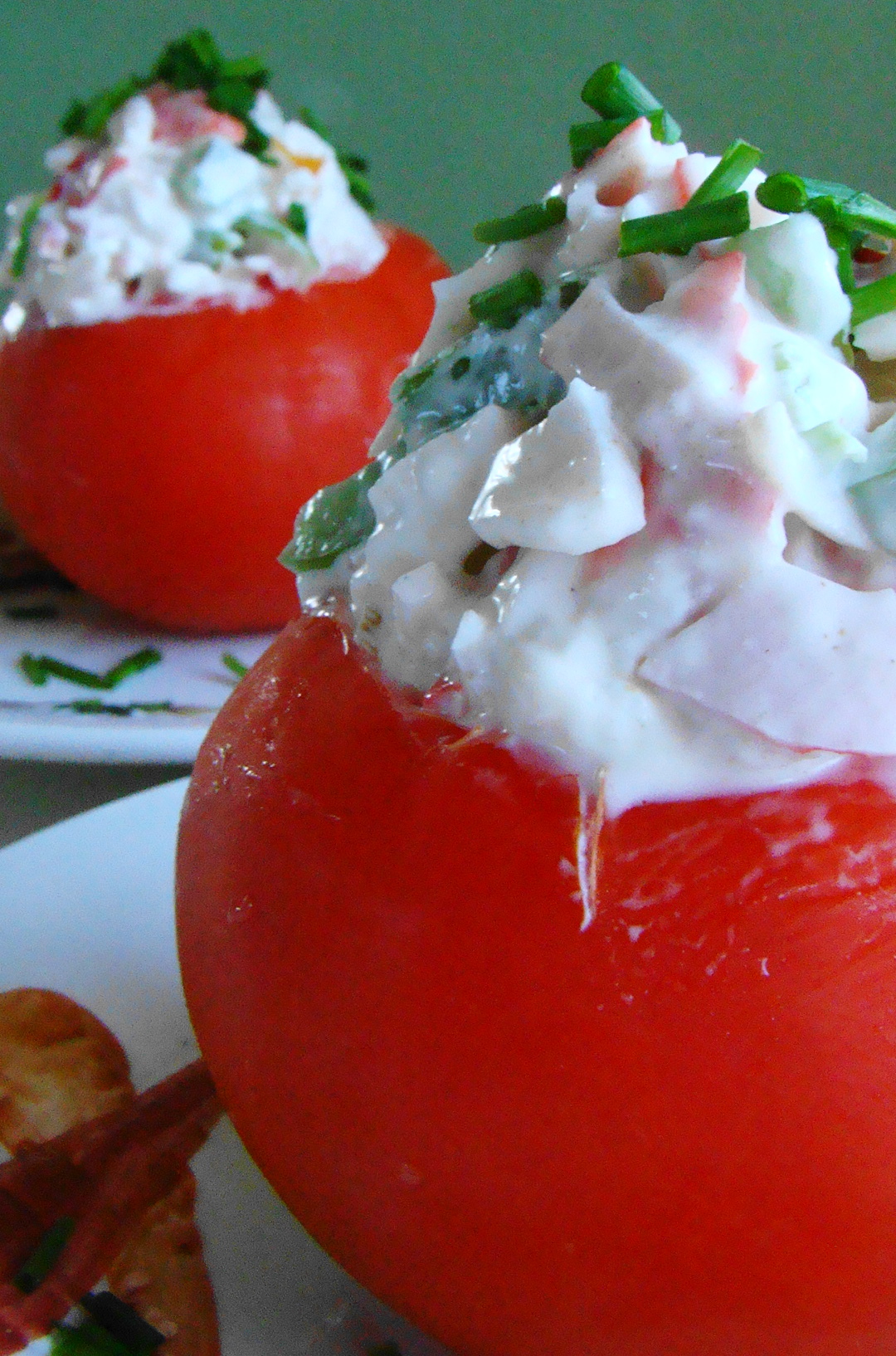 three tomatoes sitting on top of each other on a plate