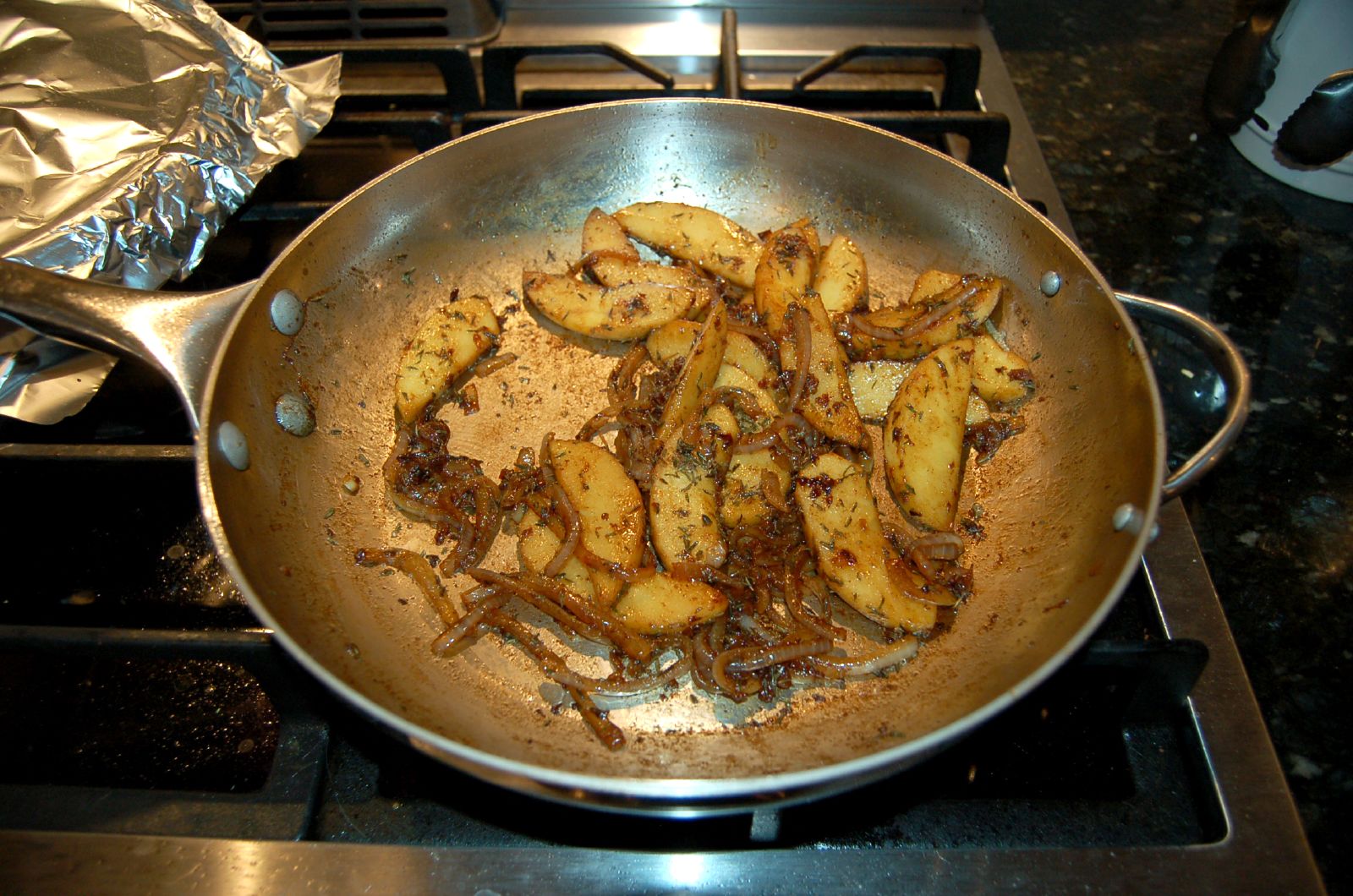 there are potatoes in the frying pan on the stove