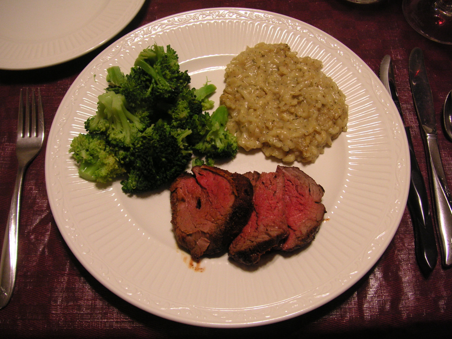 a plate that has some meat and broccoli on it