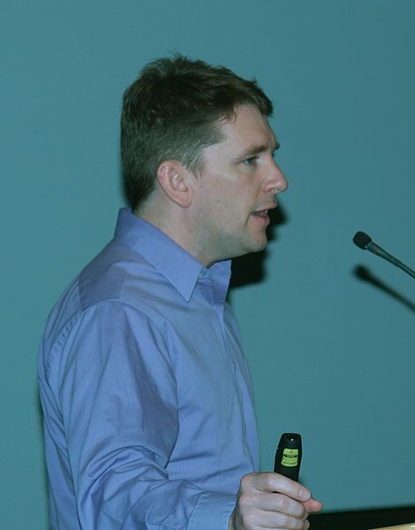 man standing at a podium giving a presentation