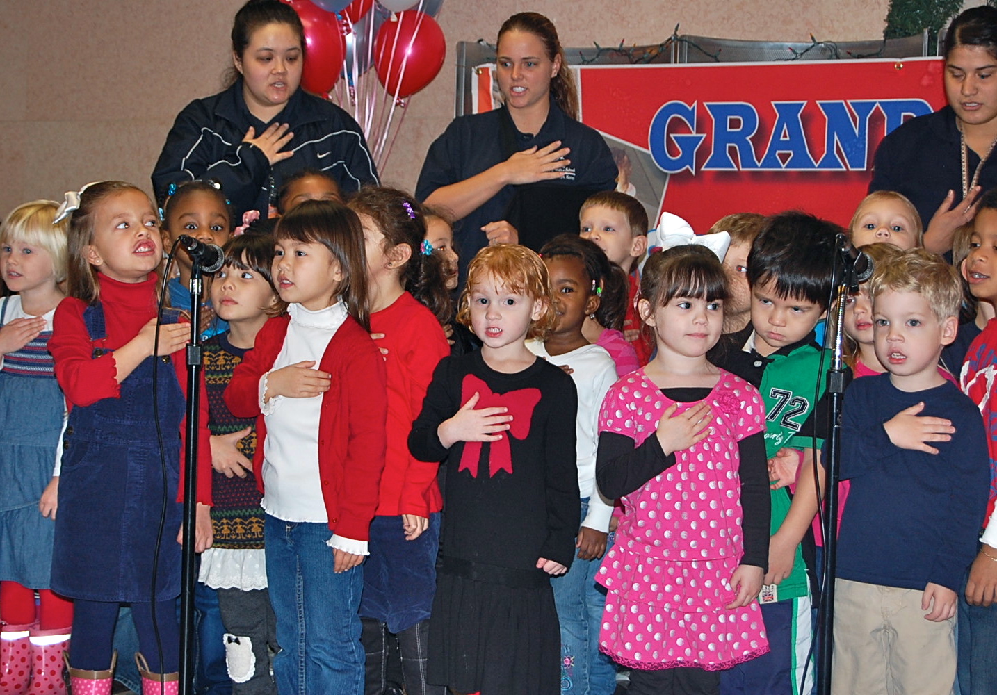 the young children are standing with their teacher for pictures