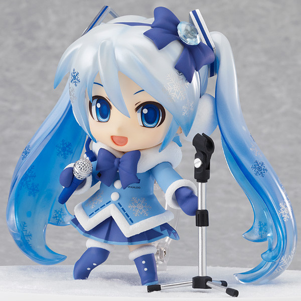 a figurine with blue hair has a microphone