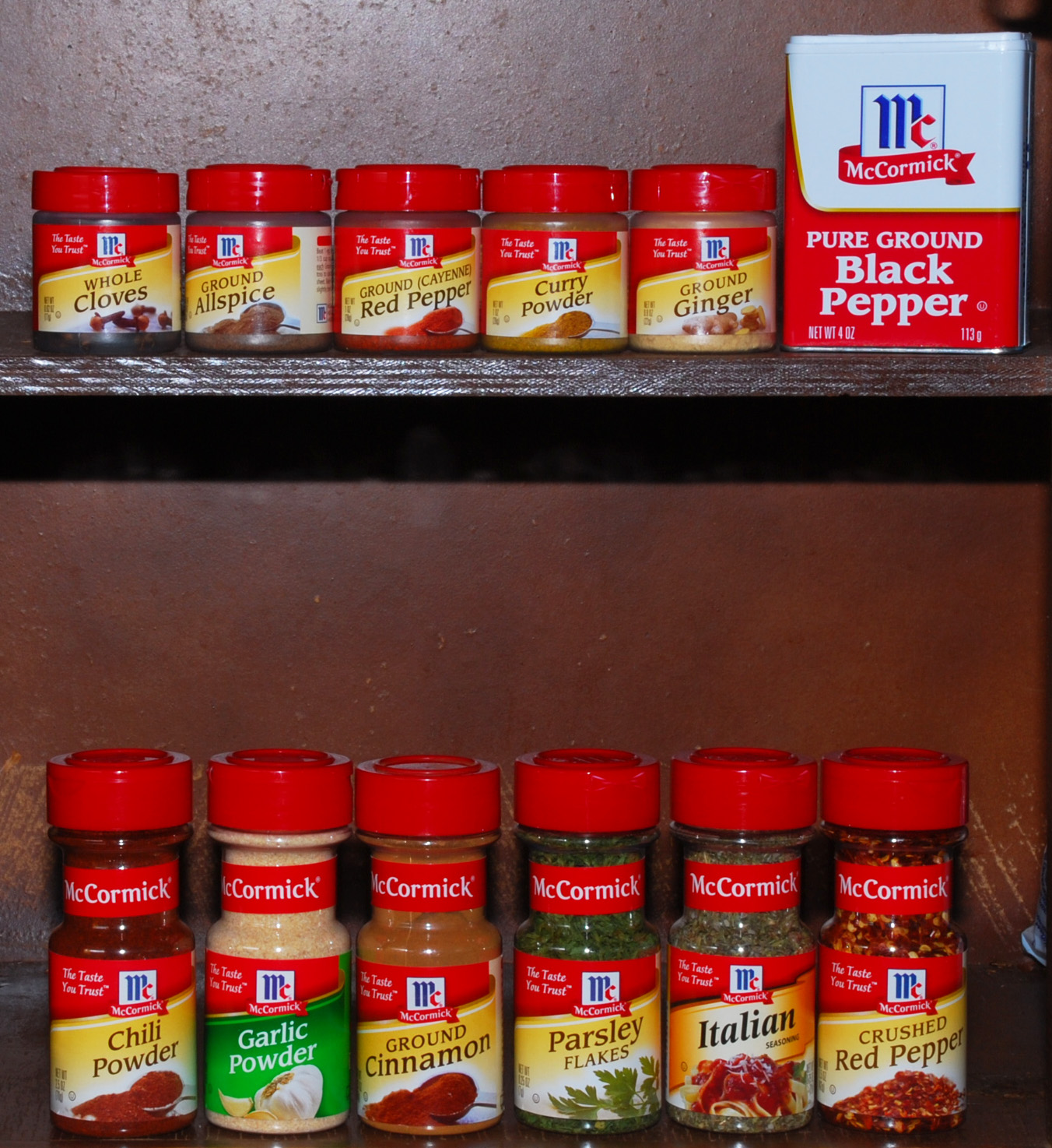 shelves in a kitchen are stocked with condiments