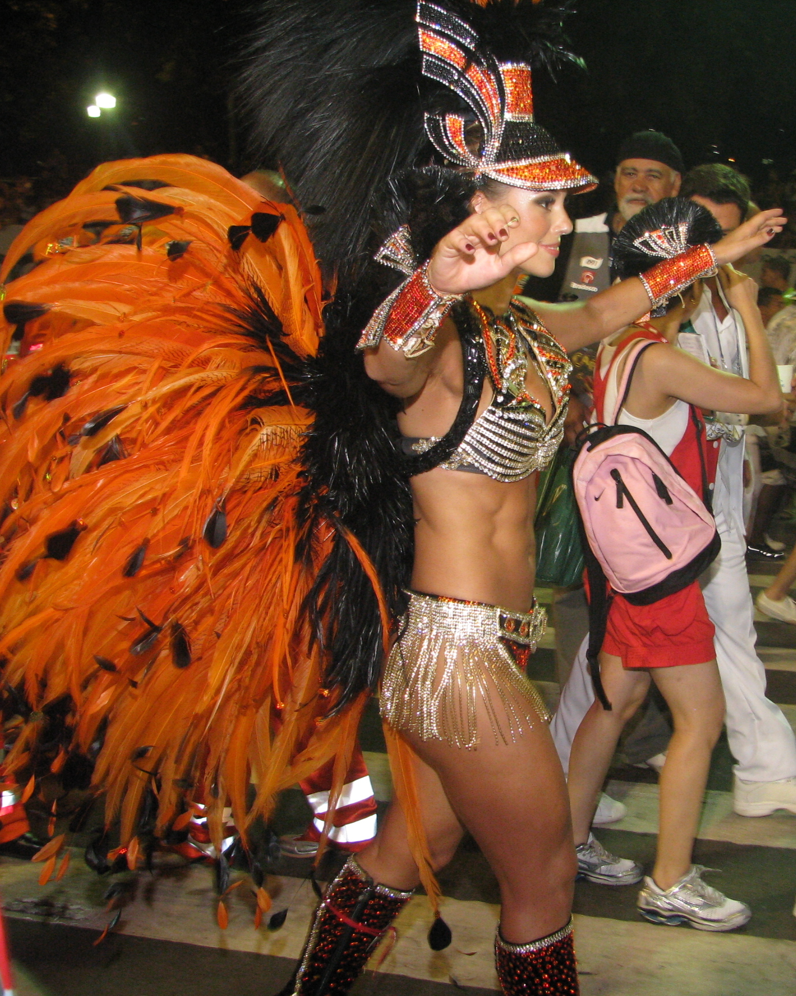 a woman in a disco outfit with a bird costume on her head