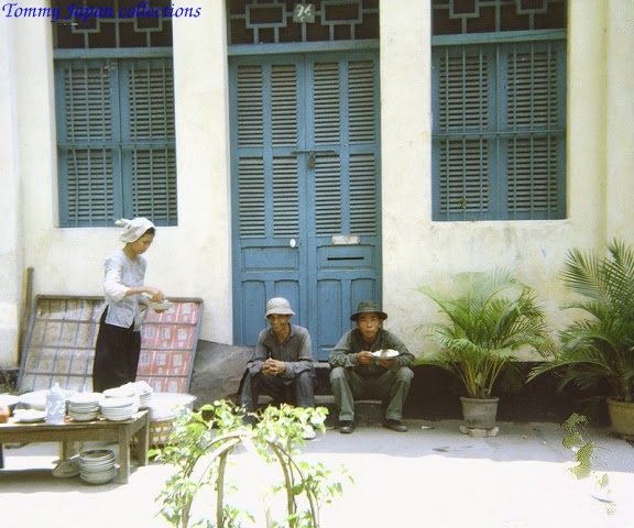 men eating a meal on a street corner