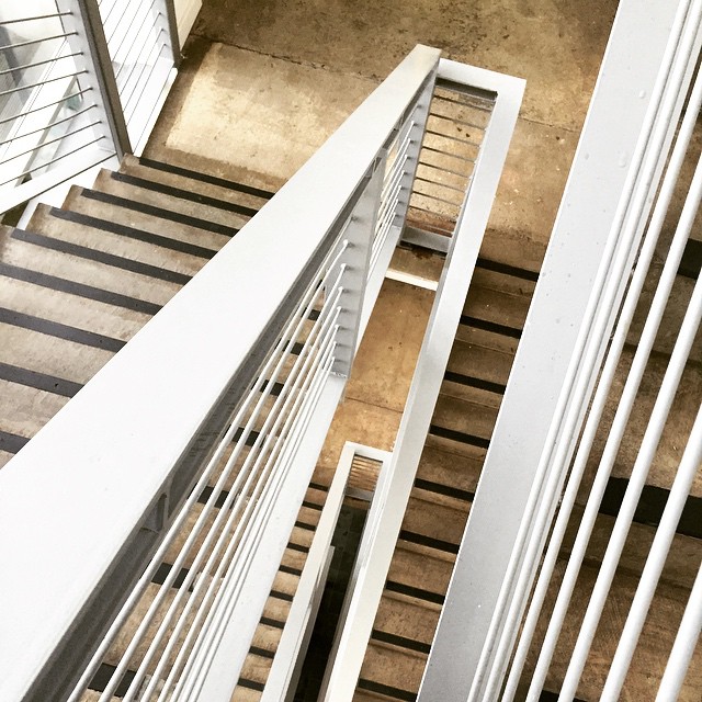 top down view of some white balconies and stairs