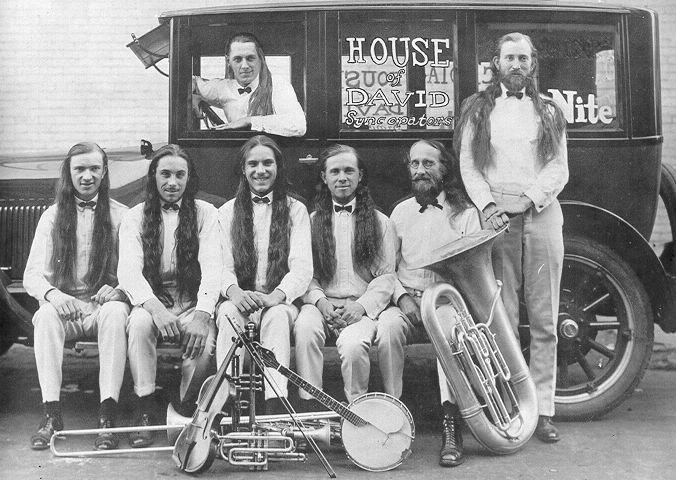 a group of musicians are posing in front of a truck